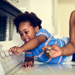 child changing the knobs on the dryer