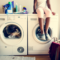 kid sitting on washer